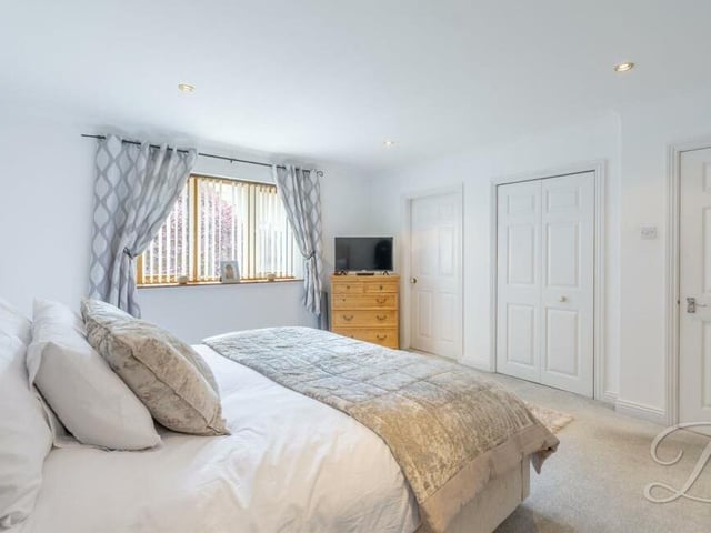 This bedroom has fitted carpets, a fitted wardrobe and access to an en suite.