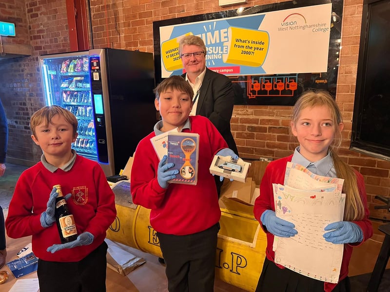 St Peter's Primary pupils Logan, Leo and Abbie with Gavin Peake and items from the capsule