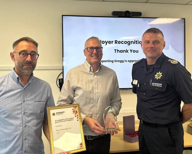 Firefighter Greg Leliwa and Eastwood firm Race Technology Ltd receive awards from CFO Craig Parkin. Photo: Submitted