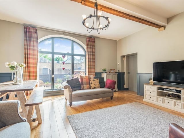 A final look at the appealing lounge, complete with its engineered oak floor and contemporary panelled walls, painted in anthracite dark grey. It really is a picture of rural living, isn't it?
