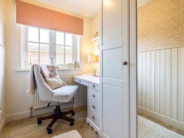 This bedroom is versatile with space for a desk or dressing table.