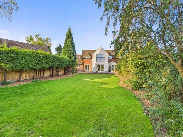 The property offers a large south-facing garden with patio, lawn, and mature planting for privacy.