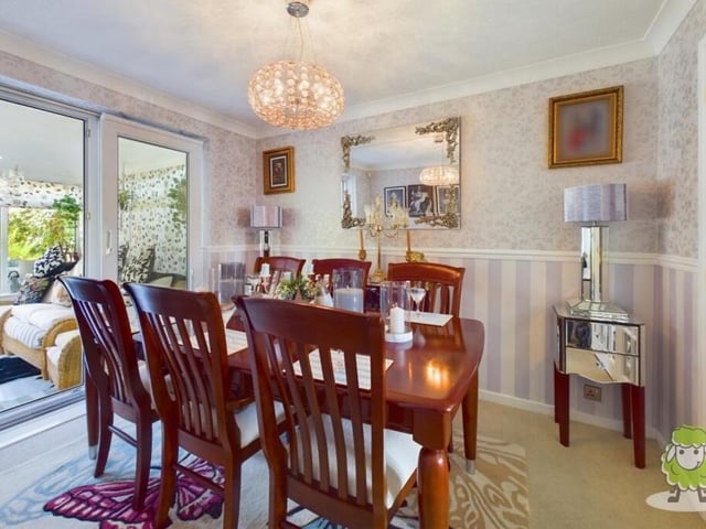 French doors from the living room beckon you into this elegant dining room, which is the perfect setting for family meals or for entertaining friends.