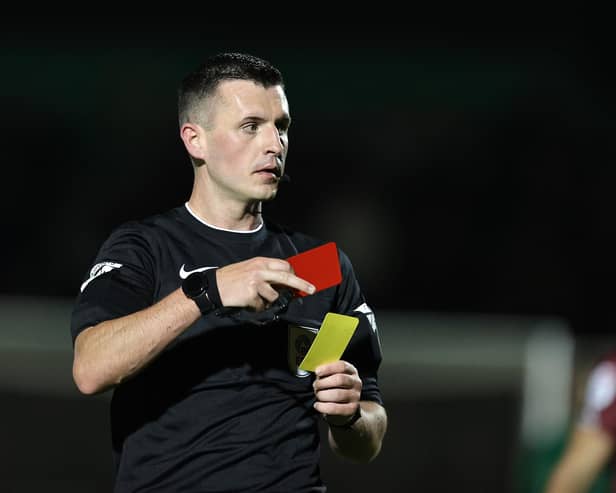 NORTHAMPTON, ENGLAND - NOVEMBER 25: Referee Lewis Smith shows a red card to Paul Digby of Cambridge United during the Sky Bet League One match between Northampton Town and Cambridge United at Sixfields on November 25, 2023 in Northampton, England. (Photo by Pete Norton/Getty Images)