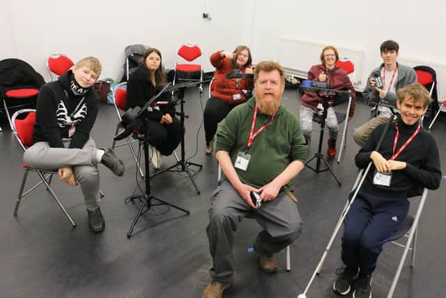 Duncan Chapman, front left, with Marshall Fairbrother, right, and the students who enjoyed the music session.