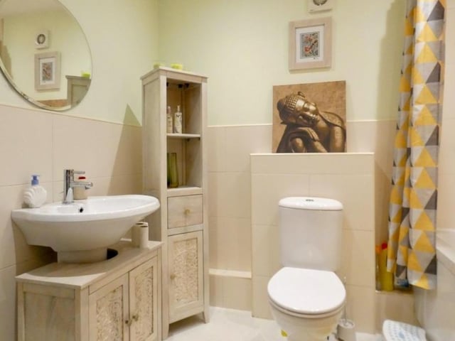 The modern, three-piece bathroom on the first floor is charming, little number.