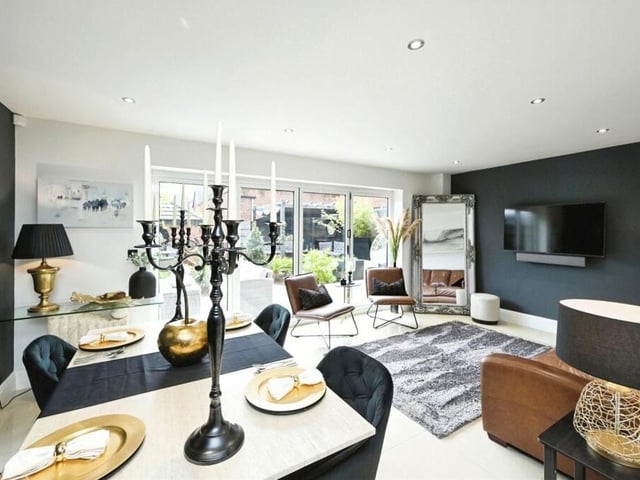 We start our tour of the £400,000 Mansfield property on the ground floor, much of which is dedicated to an open-plan layout that contains a kitchen and this lounge and dining area. Art the far end are double-glazed bi-folding doors that lead to the back garden.