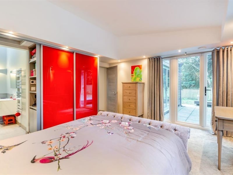 The marvellous master bedroom at the Newstead Abbey Park bungalow has access to an en suite bathroom (left) and also to the rear garden via French doors (right).