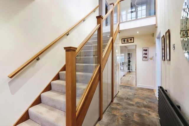Time to take a look at the first floor now, so let's pass through the entrance hall, which has built-in storage underneath, and climb the attractive staircase.