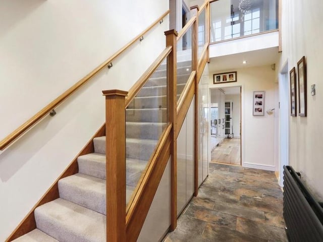 Time to take a look at the first floor now, so let's pass through the entrance hall, which has built-in storage underneath, and climb the attractive staircase.