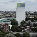 A sign with 'Grenfell Forever In Our Hearts' is displayed on the top of Grenfell Tower.