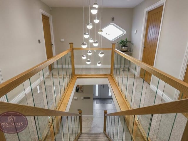 At the top of the stairs, we are greeted by this spectacular gallery landing, with ceiling spotlights and oak doors to all four double bedrooms.