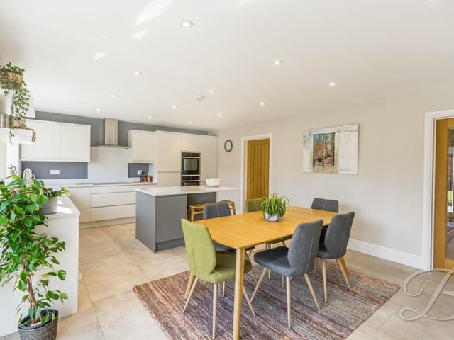 Our tour of the £535,000 Mansfield pad begins in this gorgeous and modern family-sized kitchen/diner. It comes complete with a beautiful range of matching wall and base units with quartz worktop surfaces, a tiled floor and ceiling inset spotlights.