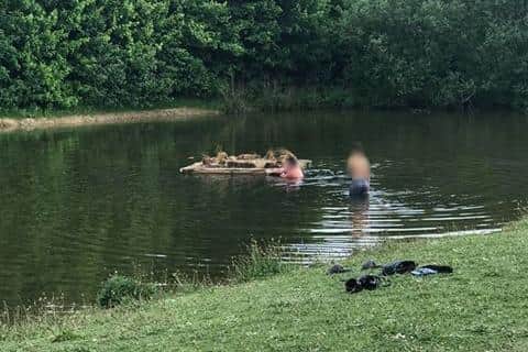 Two people were spotted swimming in the Sutton pond.