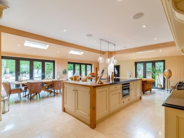 The substantial open-plan kitchen/diner, with living space, can only be described a spectacular. There are three sets of contemporary, aluminium bi-fold doors that lead outside, while the large island in the centre features black granite work surfaces, an inset stainless steel sink and additional butcher's block work surfaces at each end.