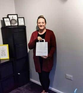 The manageress at William Hill, Shirebrook, Charlotte Charlesworth with one of the lunchbags