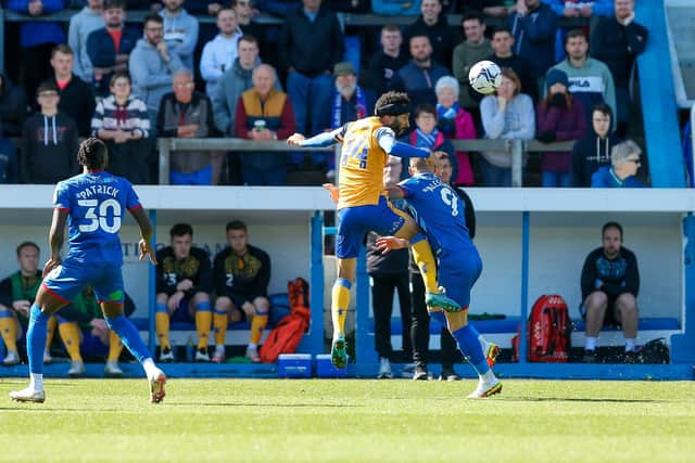 Mansfield Town defender James Perch wins the header. Photo by Chris Holloway/The Bigger Picture.media