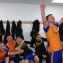 Rhys Oates leads the dressing room celebrations.