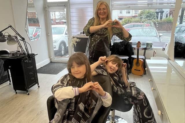 Freja and Sofija in the salon with Sofija's mum Jurgita who is also a hairdresser. Photo: Submitted