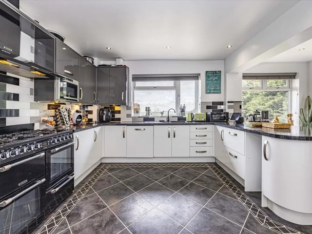 The modern and stylish kitchen is bathed in natural light and boasts a host of units and appliances