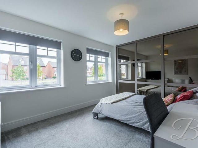 Built-in wardrobes are a feature of four of the five bedrooms, including this one, which has windows facing the front of the Mansfield property.