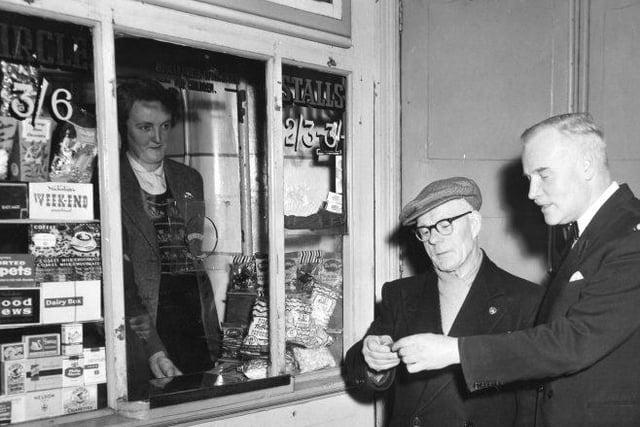 Paying for tickets at the Empire at ticket booth four. Did you visit this cinema?