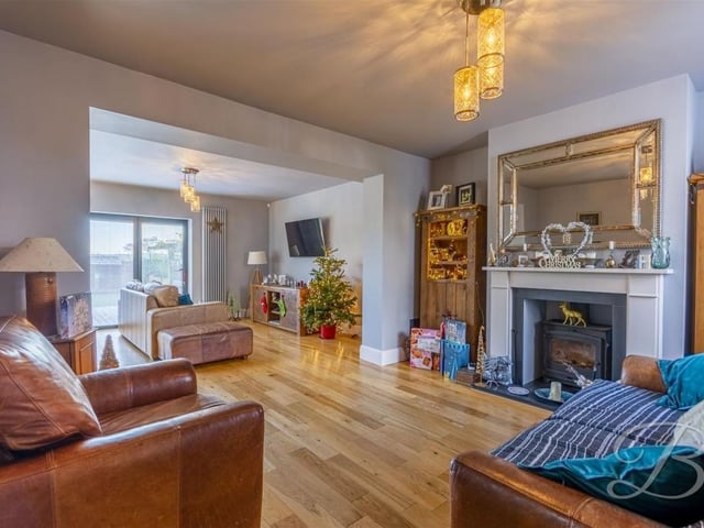 With feature log burner and opening into the kitchen area.