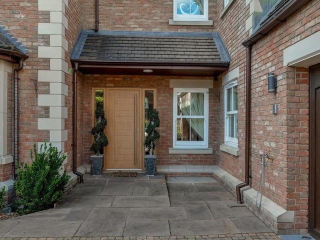 An open-fronted storm porch leads to a contemporary, composite front door that gives a suitably warm welcome to such a special property.
