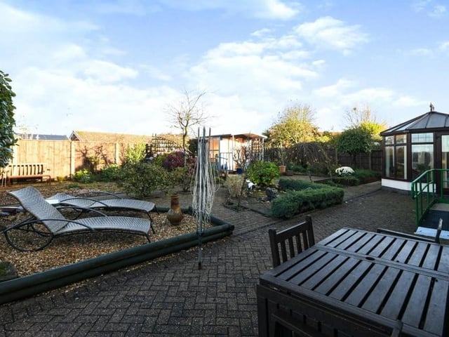 The garden at the back of the bungalow is low-maintenance. As well as lovely seating areas, it boasts a wildflower patch, a summer house and a shed. The conservatory is to the right of the picture.