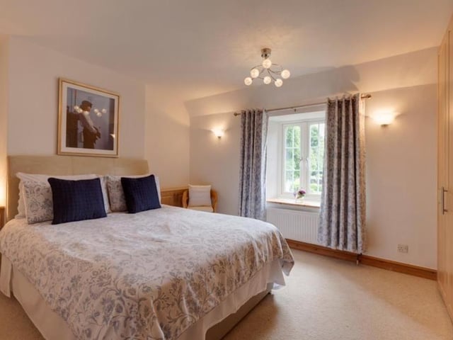 As with all the bedrooms, the third one comes complete with a range of fitted furniture, with shelves, drawers and cupboards. It overlooks the front of the £950,000 property.
