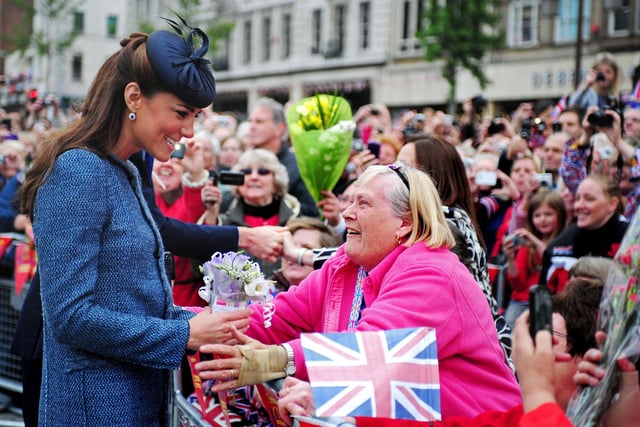 Britain's Catherine, then Duchess of Cambridge - now Princess of Wales, smiles as she meets members of the public in Market Square during a visit to Nottingham, central England, on June 13, 2012 with Britain's Queen Elizabeth II. The Queen accompanied by Prince William and Catherine, Duchess of Cambridge attended several engagements during a visit to the city as the Queen continued her diamond jubilee tour. AFP PHOTO / POOL / RUI VIEIRA (Photo by RUI VIEIRA / POOL / AFP) (Photo by RUI VIEIRA/POOL/AFP via Getty Images)