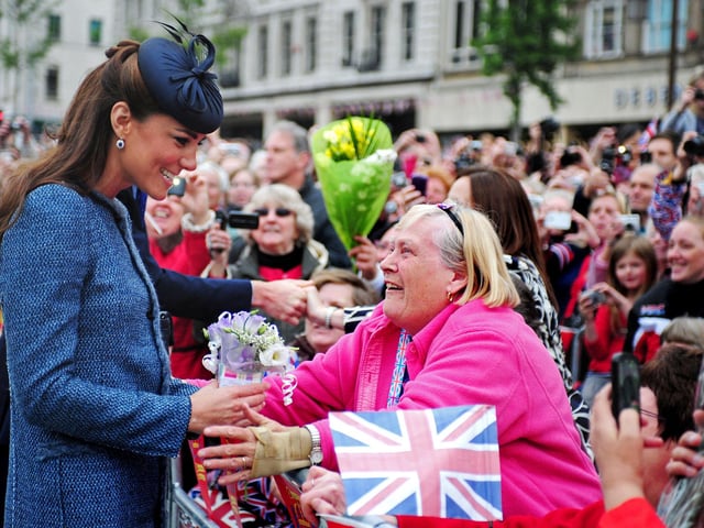 Britain's Catherine, then Duchess of Cambridge - now Princess of Wales, smiles as she meets members of the public in Market Square during a visit to Nottingham, central England, on June 13, 2012 with Britain's Queen Elizabeth II. The Queen accompanied by Prince William and Catherine, Duchess of Cambridge attended several engagements during a visit to the city as the Queen continued her diamond jubilee tour. AFP PHOTO / POOL / RUI VIEIRA (Photo by RUI VIEIRA / POOL / AFP) (Photo by RUI VIEIRA/POOL/AFP via Getty Images)