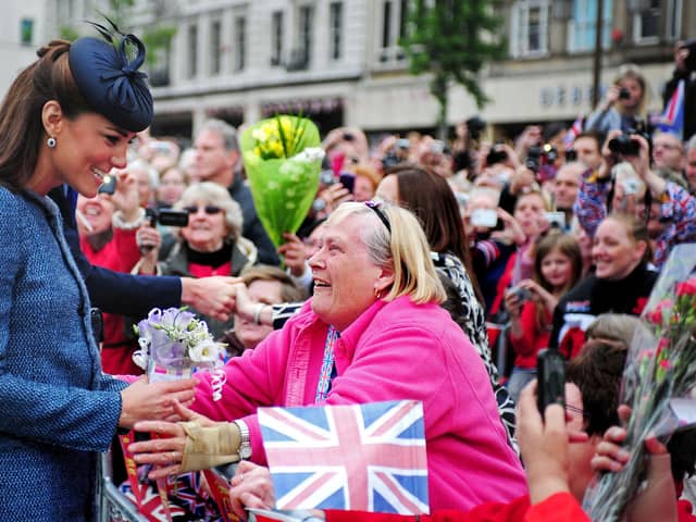 Britain's Catherine, then Duchess of Cambridge - now Princess of Wales, smiles as she meets members of the public in Market Square during a visit to Nottingham, central England, on June 13, 2012 with Britain's Queen Elizabeth II. The Queen accompanied by Prince William and Catherine, Duchess of Cambridge attended several engagements during a visit to the city as the Queen continued her diamond jubilee tour. AFP PHOTO / POOL / RUI VIEIRA (Photo by RUI VIEIRA / POOL / AFP) (Photo by RUI VIEIRA/POOL/AFP via Getty Images)
