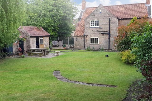 A better view of the patio area, with seating space, in the picturesque garden