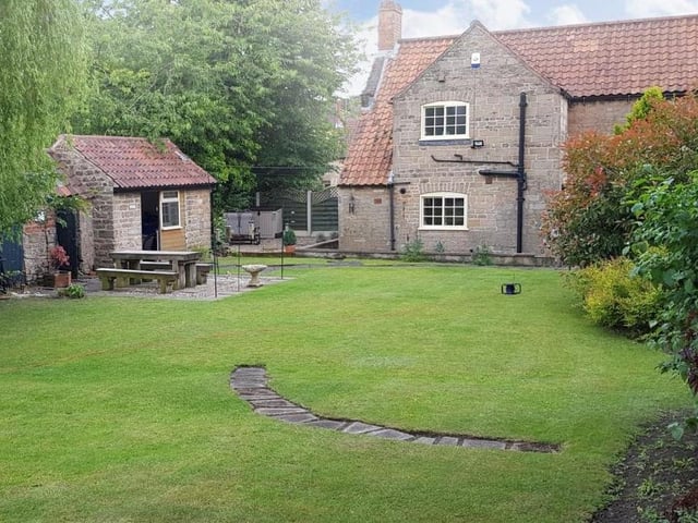 A better view of the patio area, with seating space, in the picturesque garden