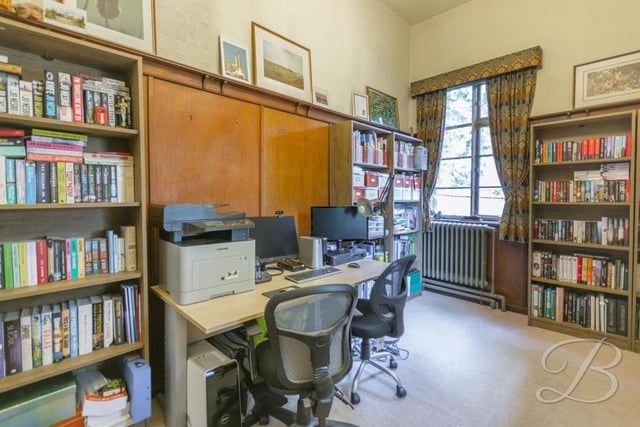 If you find yourself working from home, this office is sure to prove useful. It features wooden panelling, a carpeted floor and windows overlooking the side and back of the mansion.