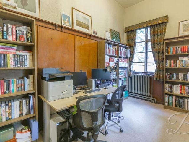 If you find yourself working from home, this office is sure to prove useful. It features wooden panelling, a carpeted floor and windows overlooking the side and back of the mansion.