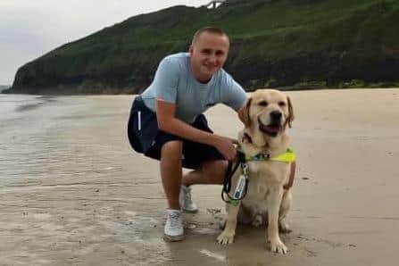 Blind footballer Nathan Edge with guide dog Hudson.