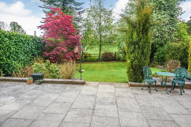 The house stands in large established lawned gardens, directly overlooking surrounding paddocks.