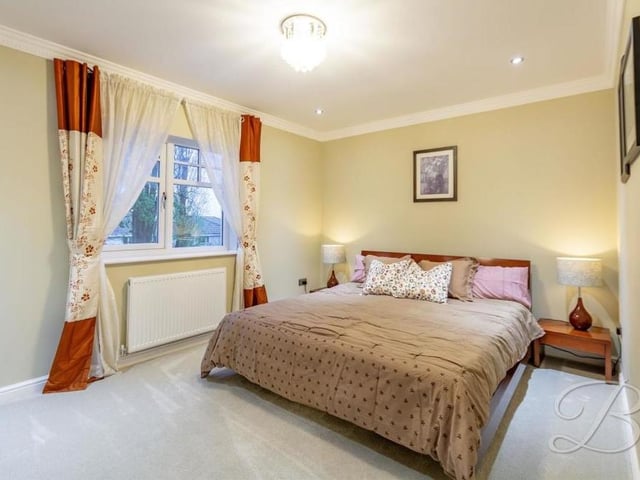Another appealing, good-sized bedroom, with a carpeted floor and downlights. The window overlooks the back garden.