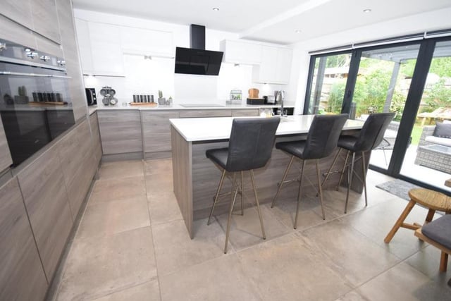 Staying in the kitchen, the feature centre island is inset with sink and drainer, and also incorporates a functional breakfast bar with seating. Bi-folding doors open straight out to the back garden and terrace patio, which is ideal for the summer, bringing the outside in.