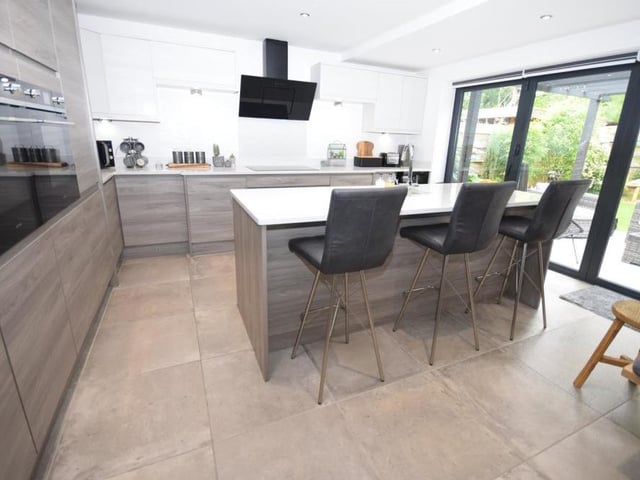 Staying in the kitchen, the feature centre island is inset with sink and drainer, and also incorporates a functional breakfast bar with seating. Bi-folding doors open straight out to the back garden and terrace patio, which is ideal for the summer, bringing the outside in.