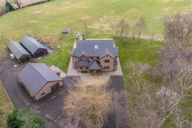 We close our gallery with this aerial image of the circular driveway that leads to the entrance of the property and the garage/workshop. No-one can complain about a lack of off-street parking space!