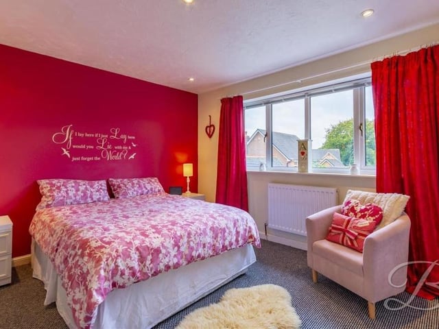 A chic second bedroom overlooks the back of the Mansfield house. It boasts a fitted wardrobe, carpeted floor and downlights.
