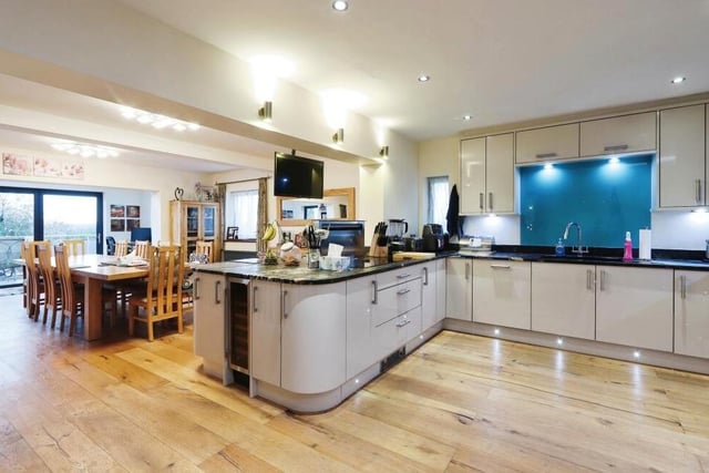 The highlight of the ground floor is this modern, open-plan kitchen that embraces a dining area, which is ideal for family gatherings and entertaining guests, and also a snug. Note the engineered oak flooring.