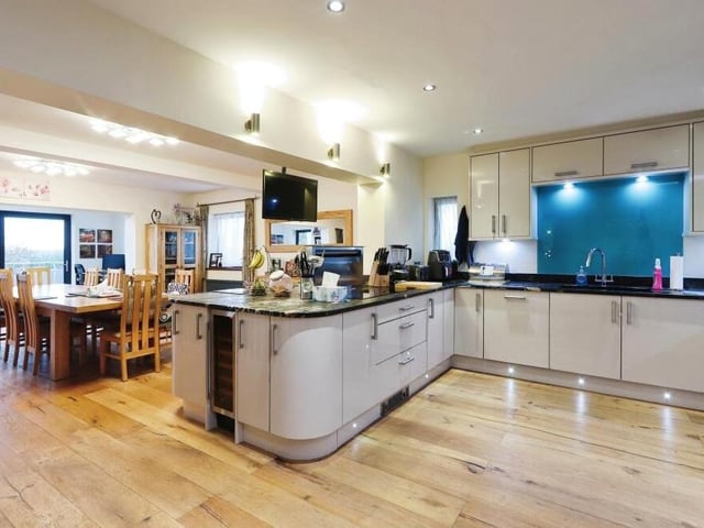 The highlight of the ground floor is this modern, open-plan kitchen that embraces a dining area, which is ideal for family gatherings and entertaining guests, and also a snug. Note the engineered oak flooring.