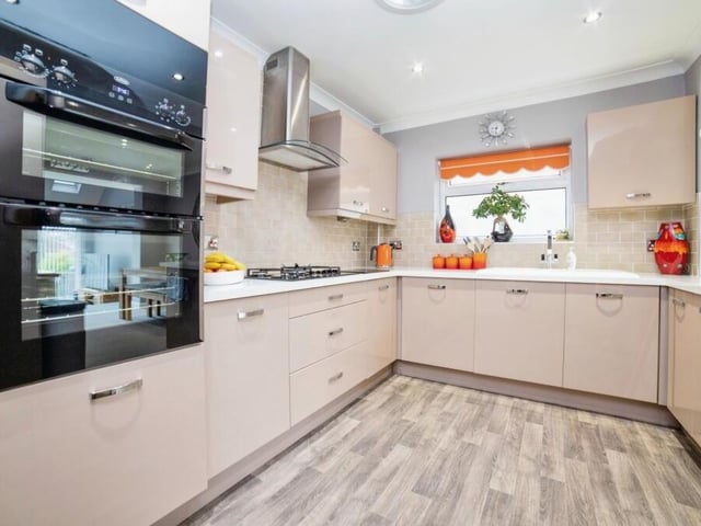 Next stop is this sleek kitchen diner, complete with contemporary, integrated appliances and smart, matching storage units.