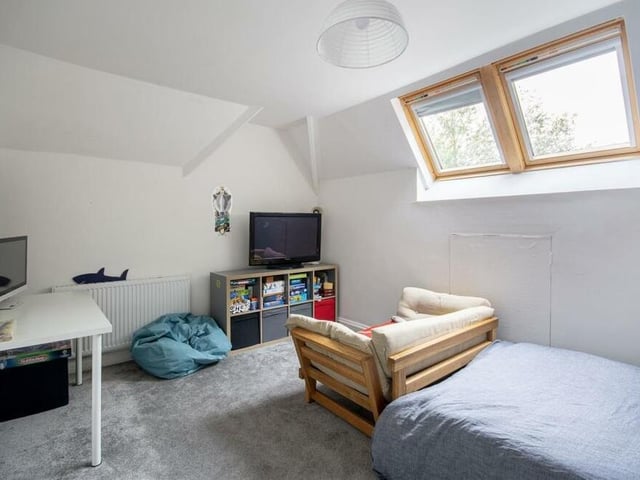 This second-floor bedroom has lots of space. Natural light flows through two Velux windows.