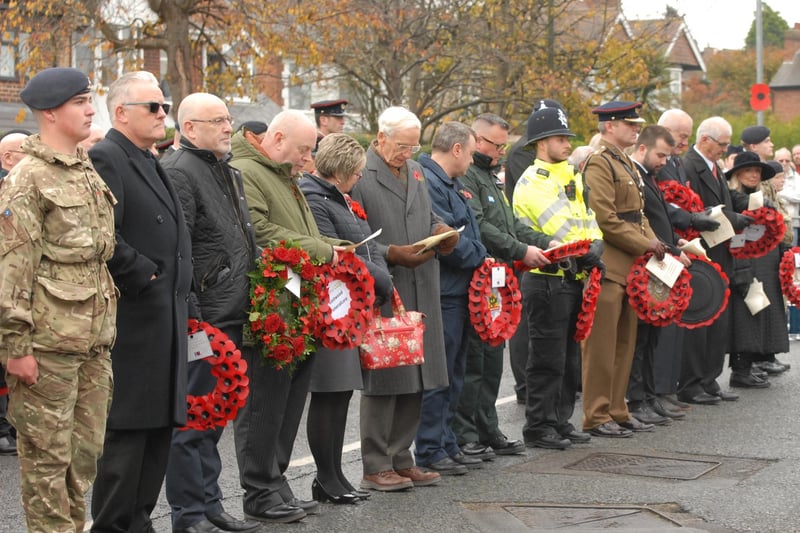 Dignitaries and members of the uniformed services and community groups prepare to lay wreaths in Eastwood