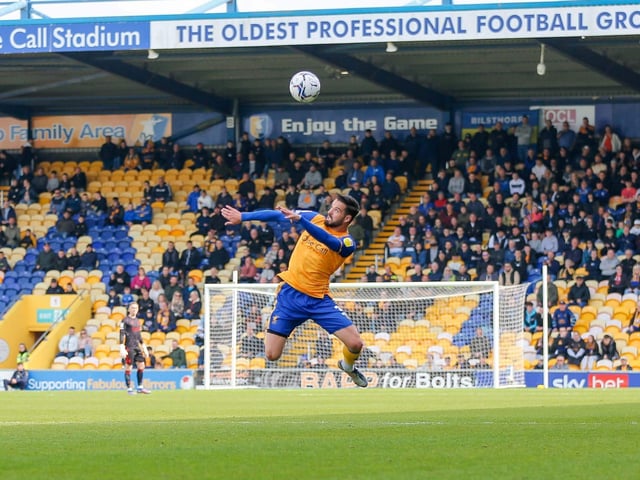 Stephen McLaughin gets up for the ball against Crawley Town.